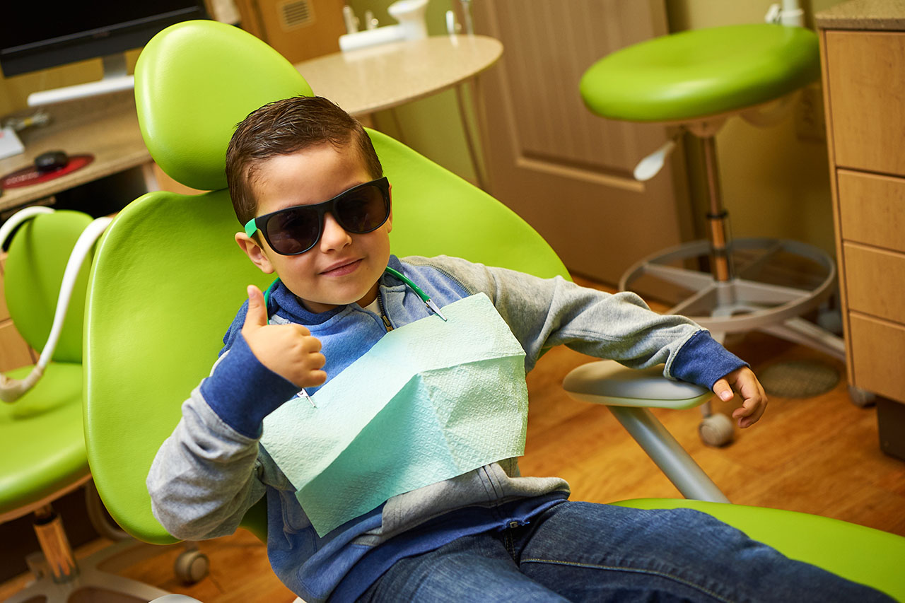 Child Giving Thumbs Up After Dentist Visit